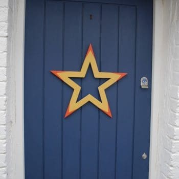 Yellow, orange and blue painted wooden star wreath