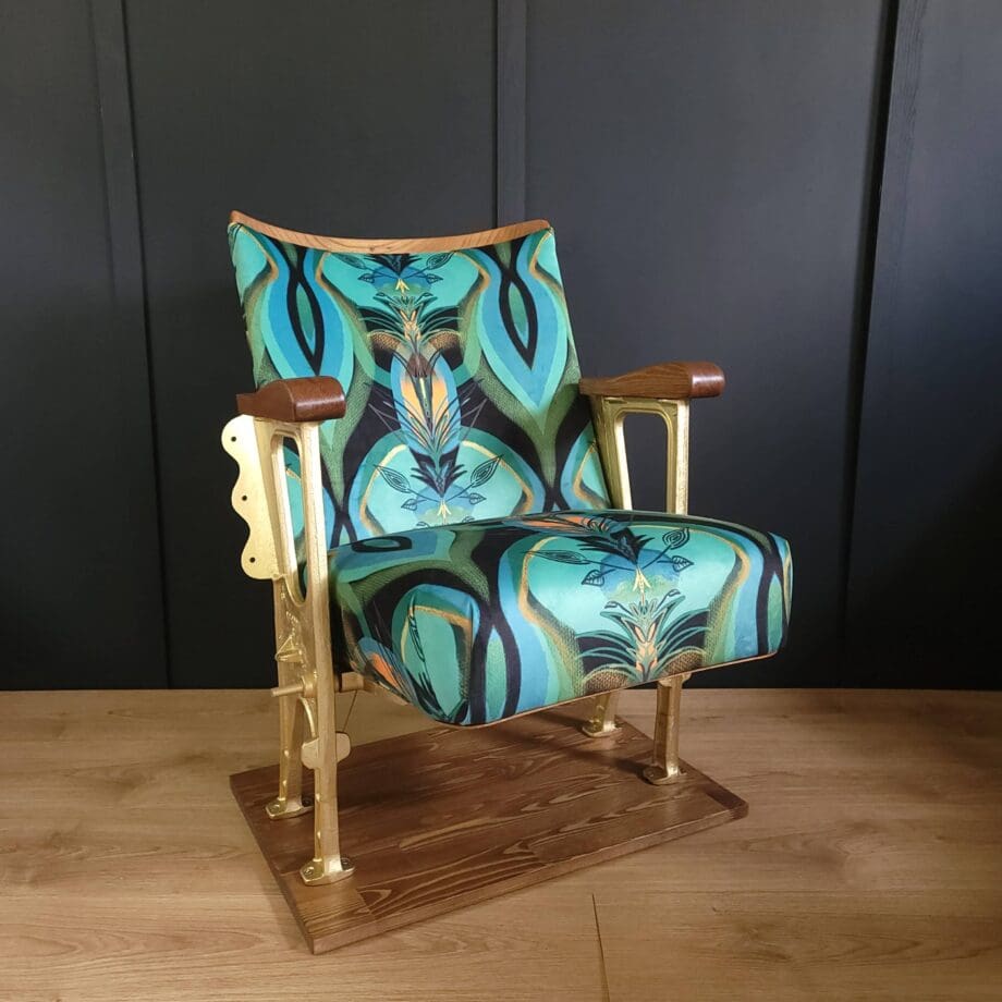 Single vintage cinema seat in a teal patterned velvet