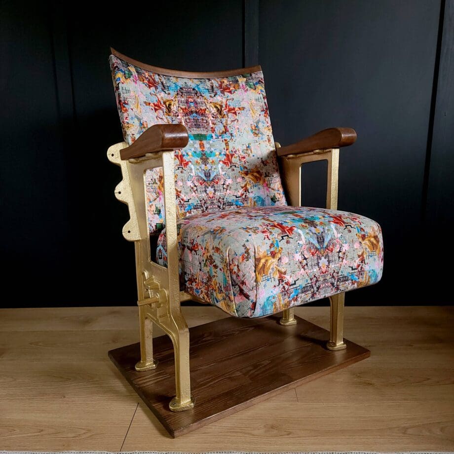 Single vintage cinema seat in a patterned velvet with gold legs